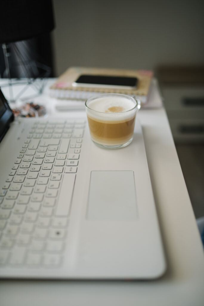 Wealthy Affiliate review: coffee and laptop on a productive morning workspace
