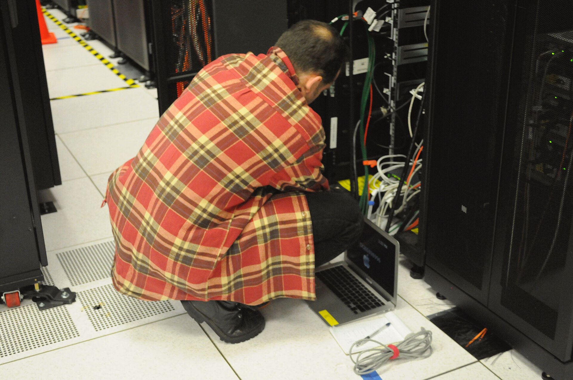 Technician maintaining server rack — Bluehost keeps servers online, the business is up to you