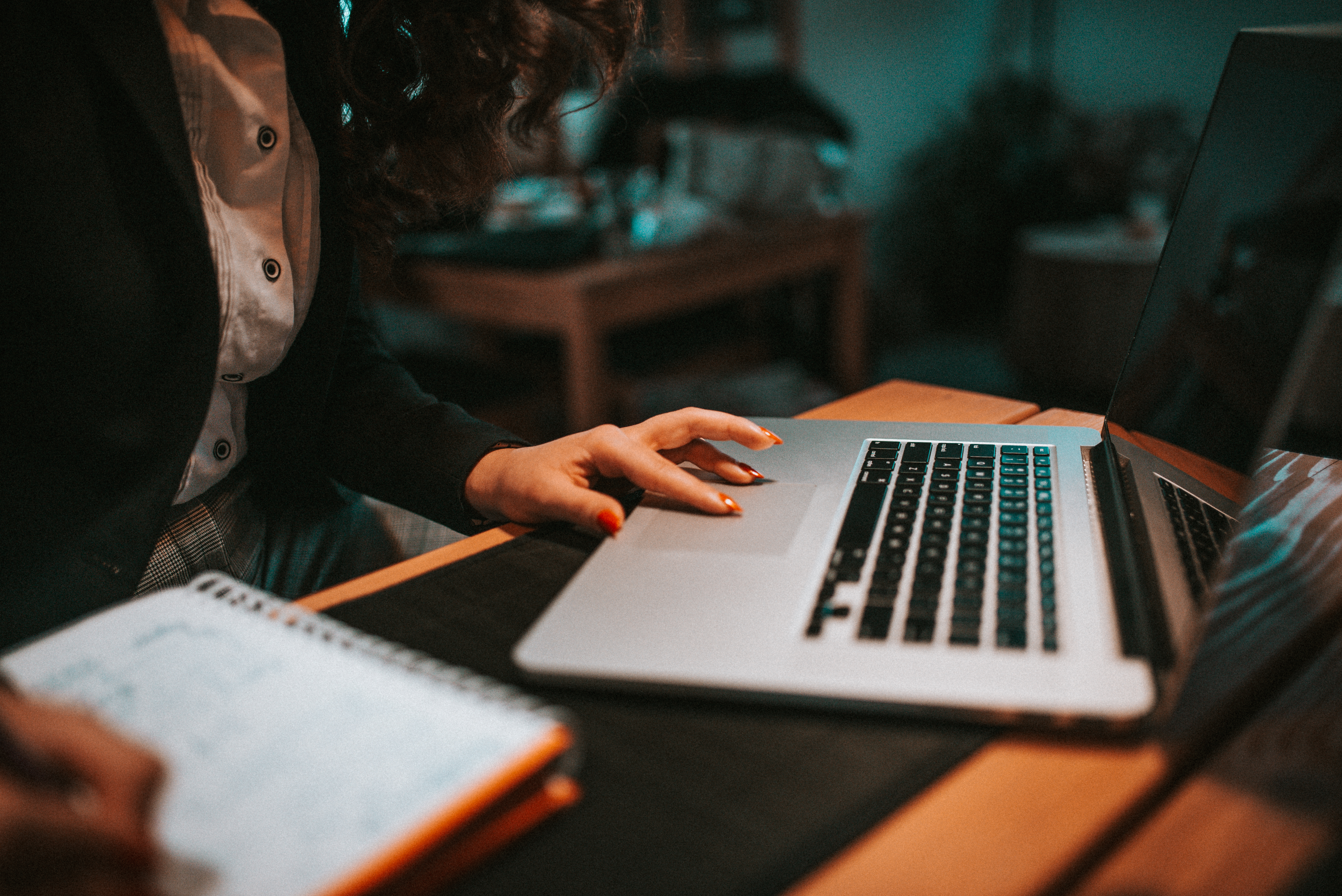 Hands typing on a laptop while doing keyword research for an affiliate marketing website