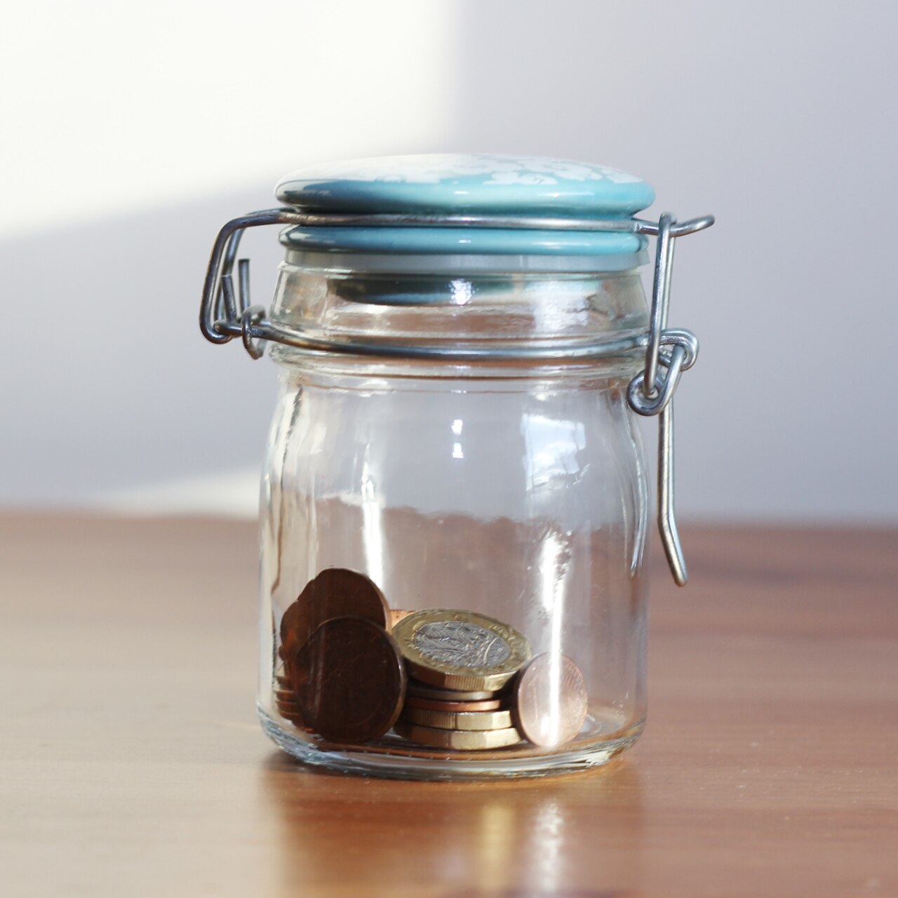 Coins and savings, representing the small recurring costs of a website