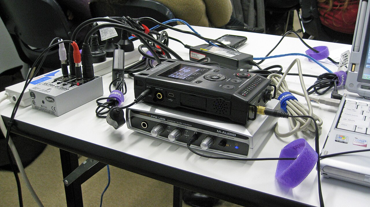 A webinar and podcast recording setup with a laptop and microphone
