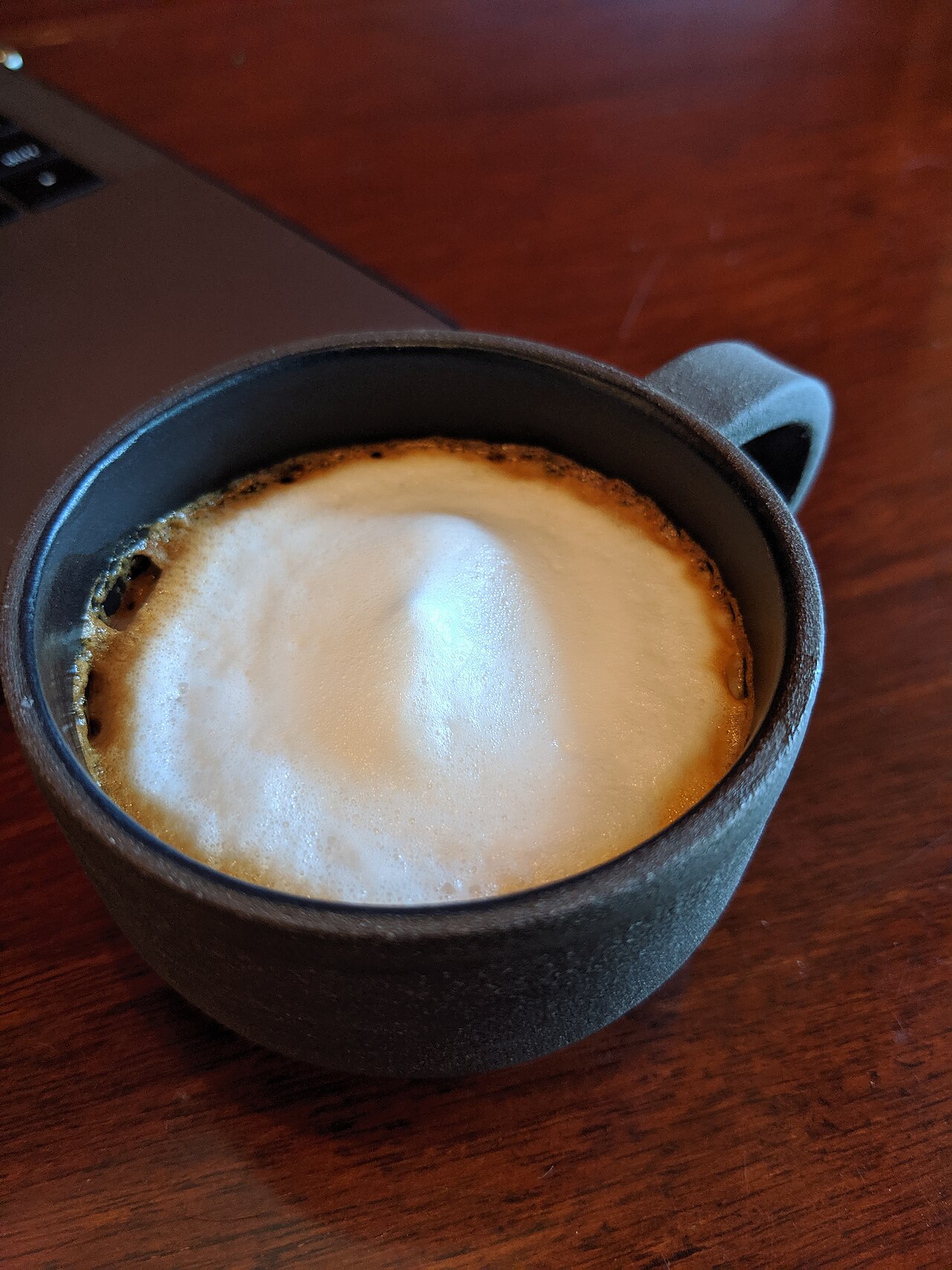 Working through online business training with a coffee