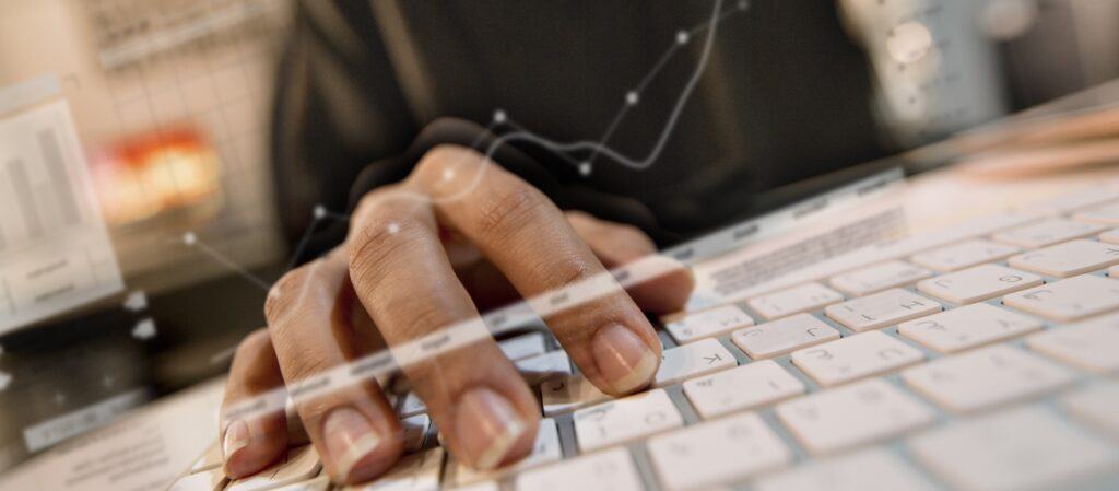 Person typing at a keyboard with digital overlays representing digital product affiliate programs