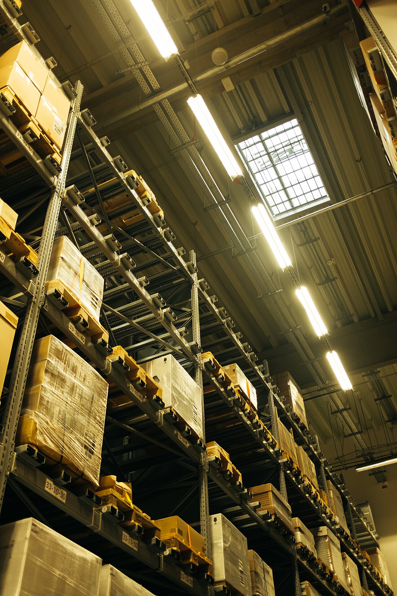 Warehouse shelves stocked with boxes representing ecommerce inventory costs