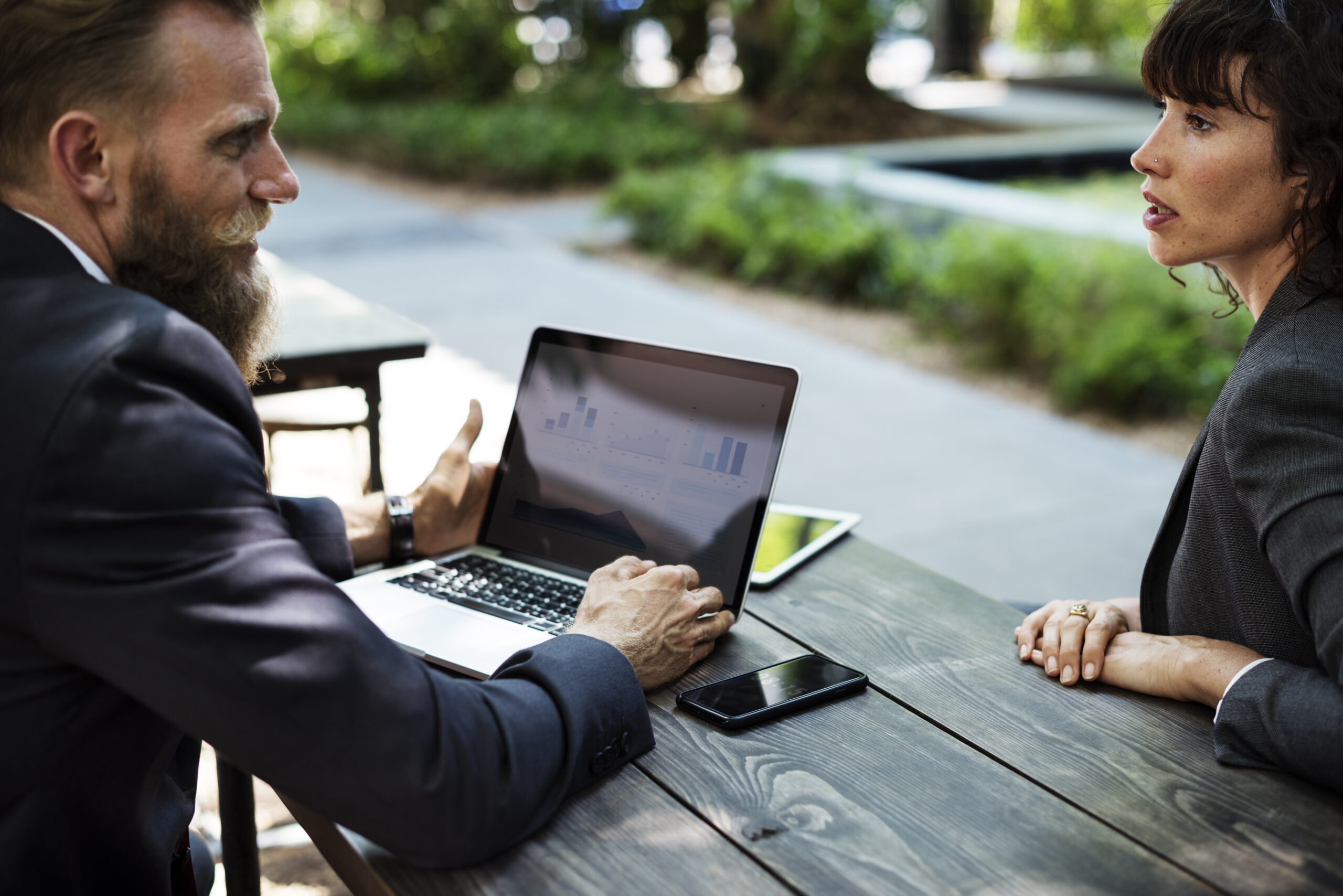 Two people discussing strategy together over a laptop
